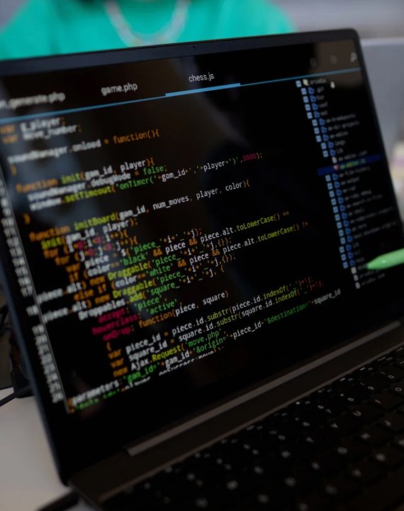 Laptop screen displaying colorful code in a text editor during the custom development of a web application.